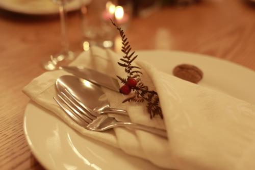 a fork and knife on a plate on a table at JOEN Village in Librazhd