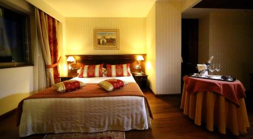 Postel nebo postele na pokoji v ubytování Hotel Calissano