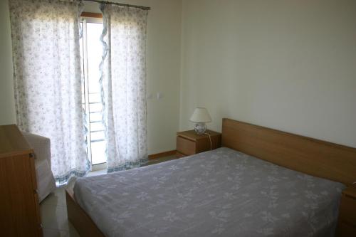 - une chambre avec un lit et une grande fenêtre dans l'établissement Encosta Da Orada by Garvetur, à Albufeira