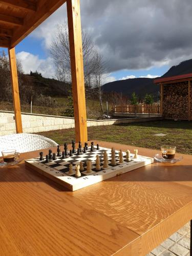 a chess board on a wooden table on a patio at JOEN Village in Librazhd