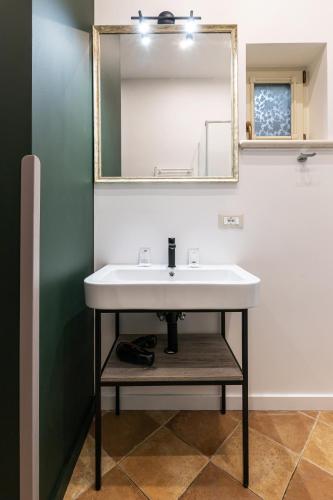 a bathroom with a sink and a mirror at Oysters & Bubbles Gastro Hotel. Rynok square in Lviv