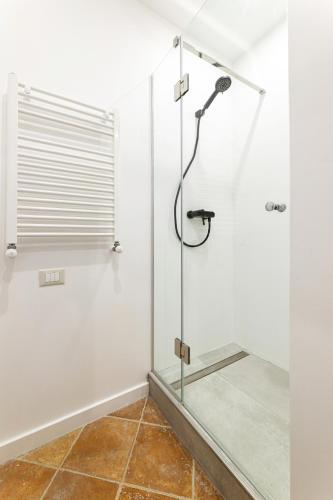 a shower with a glass door in a bathroom at Oysters & Bubbles Gastro Hotel. Rynok square in Lviv