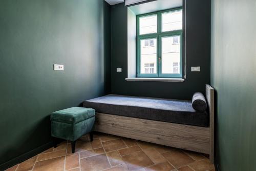a small room with a bed and a window at Oysters & Bubbles Gastro Hotel. Rynok square in Lviv