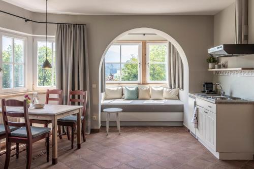 a kitchen and living room with a couch in a room at Villa Gloria in Soprabolzano