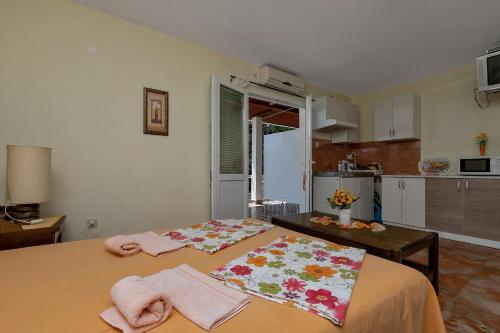 a bedroom with a bed with towels on it at Vila Milena in Krvavica