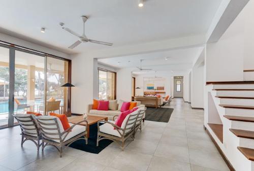 a living room with a table and chairs at Sangria Sun in Wadduwa