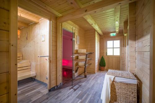 a wooden room with a sauna with a bench in it at Hotel Cafe-Zillertal in Strass im Zillertal