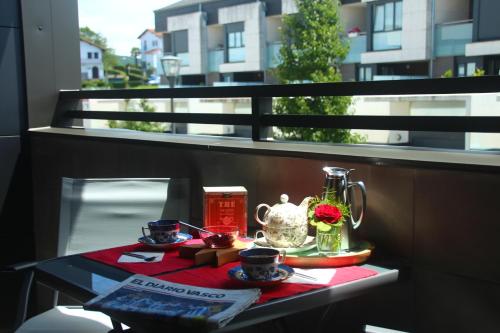 - un balcon avec une table et un service à thé dans l'établissement NICORÉS, à Irún