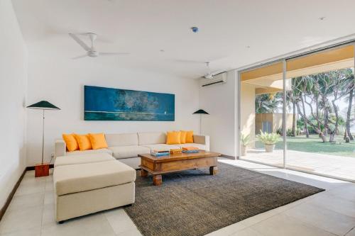 a living room with a couch and a coffee table at Sangria Sun in Wadduwa