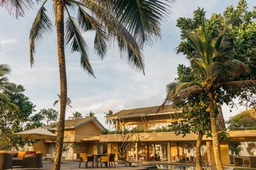 a resort with palm trees in front of it at Sangria Sun in Wadduwa