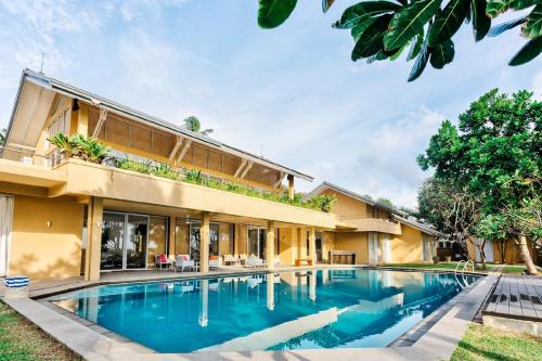 an exterior view of a house with a swimming pool at Sangria Sun in Wadduwa