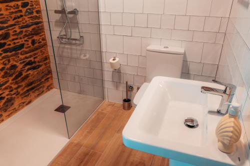 a bathroom with a sink and a shower at Pensión A Marronda in Baleira