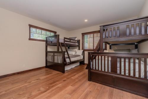 a room with stairs and bunk beds in a house at Mountainside 4 in Mammoth Lakes