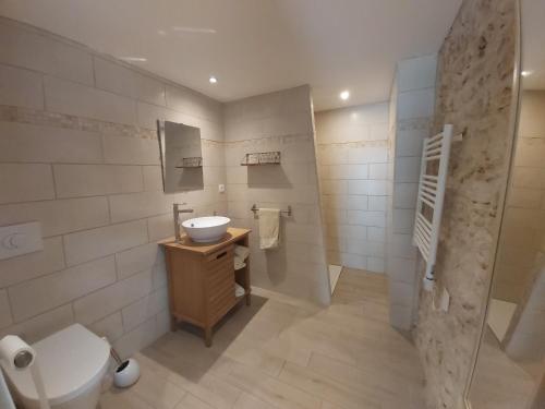 a bathroom with a sink and a toilet at Chambres d'hôtes Les Marguerites in Champdolent