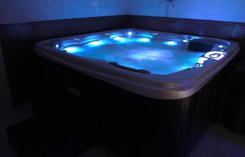 a jacuzzi tub with blue lights in a bathroom at Hotel Adria in Ruda Śląska
