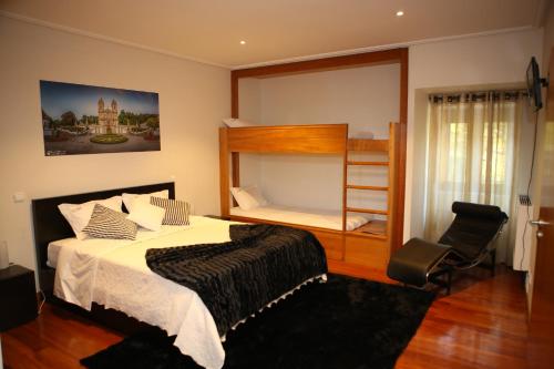 a bedroom with a bed and a bunk bed at Turismo Homes Solar Do Areal in Braga