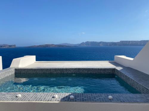 a swimming pool with a view of the water at Kokkinos Villas in Akrotiri