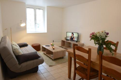 a living room with a couch and a table at Le Cerf-Volant in Dieppe