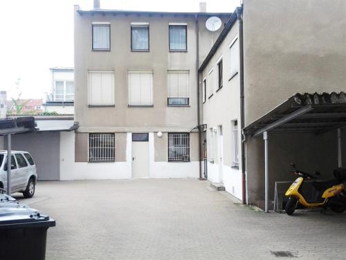 a scooter parked in a parking lot next to a building at Maffei Apartments in Nuremberg