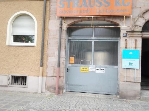 a front door of a building with a sign on it at Maffei Apartments in Nürnberg