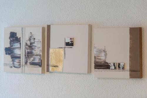 three photographs of a refrigerator hanging on a wall at Abendstern in Saas-Almagell