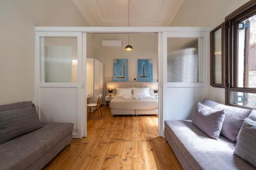 a living room with a bed and a couch at Letty's House - Old Town Luxury Mansion in Rhodes Town