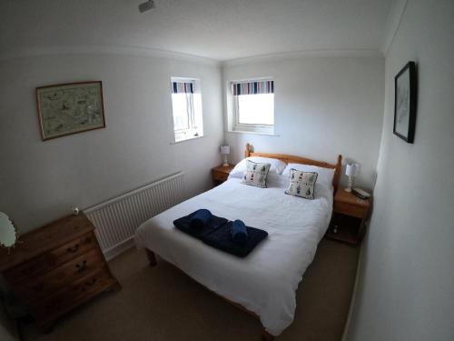 イースト・カウズにあるAnchor Cottageのベッドルーム1室(青いタオル2枚付)
