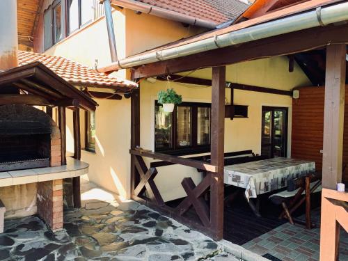 a porch of a house with an outdoor patio at Casa Maria Izvorul Muresului in Izvoru Mureşului