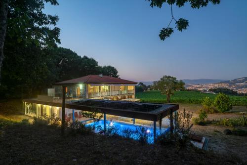 a house with a pool in front of it at Braga House & Wine in Braga