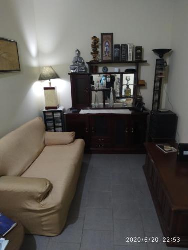 a living room with a couch and a table at Casa Rosário Centro de Amparo in Amparo