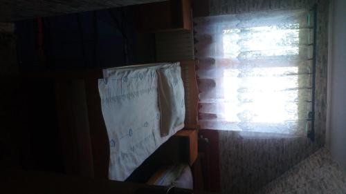 a room with a window and a sheet of paper at aura in Suwałki