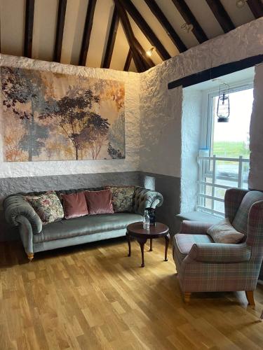 a living room with a couch and a table at The 1645 Inn in Nairn
