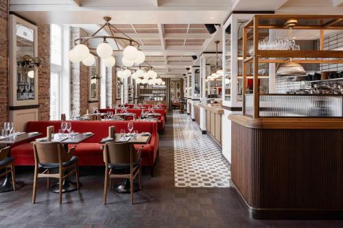 a restaurant with red chairs and a bar at Villa Copenhagen in Copenhagen