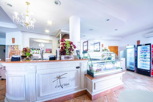 a shop with a counter with a flower display at Hotel il Faro di Molara in Porto San Paolo
