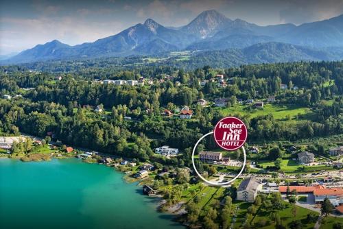 an aerial view of a lake and mountains at Hotel Faaker See Inn by S4Y in Faak am See