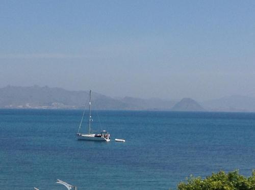 a boat in the middle of a large body of water at Triton Boutique Hotel in Kos Town