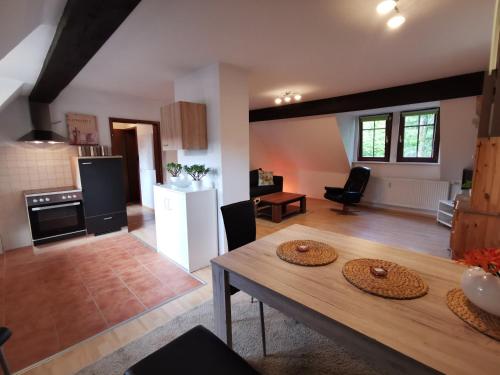 a kitchen and living room with a wooden table at Lenzenhof anno 1720 I in Schotten