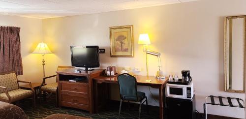 a hotel room with a desk with a television and a bed at Hampton Inn (not a Hilton Affiliate) Camp Hill - Harrisburg SW in Harrisburg