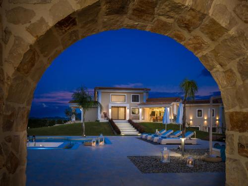 a view of a house from an archway at Villa Shangri-La Zakinthos in Zakynthos Town