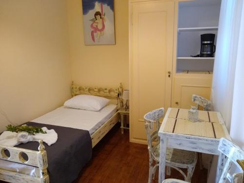 a small room with a bed and a table at Hermoupolis Syros Maisonette in Ermoupoli