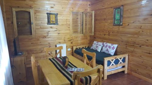 a wooden cabin with a table and chairs at Terrazas de Uspallata in Uspallata