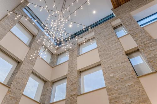 a chandelier in a building with windows at Holiday Inn - Columbus by IHG in Columbus