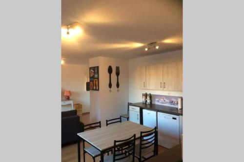 a kitchen and dining room with a table and chairs at Coeur Alsace in Colmar