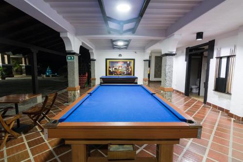 a pool table in the middle of a room at Finca Hotel La Esperanza in Montenegro