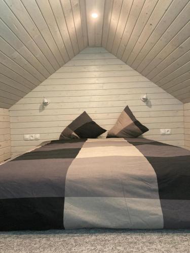 a bedroom with a large bed in a room at Holiday house Ausekļa namiņš in Cēsis
