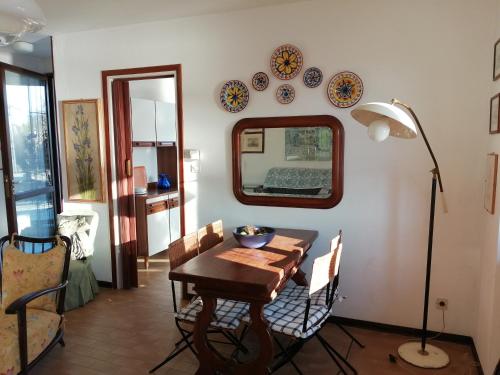 a dining room with a table and plates on the wall at Terrazza sul lago in Ameno