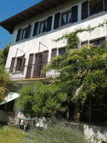 a white building with windows and a balcony at Terrazza sul lago in Ameno