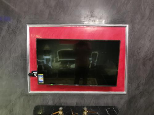 a picture of a person in a red frame on a wall at Chic Apartment 2 in Sharm El Sheikh