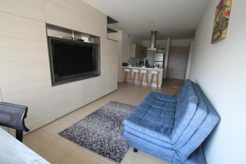 a living room with a blue couch and a tv at Premier Apartment Downtown 4 Guests 1604 in Mexico City