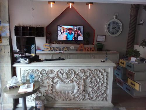 a living room with a fireplace with a tv above it at Hotel Santa Ana in San Miguel de Allende